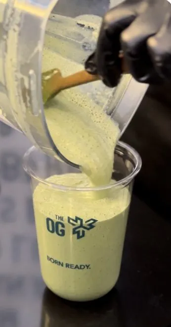 A matcha protein shake poured into an OG Born Ready cup